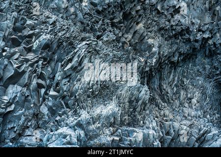 Abstract Icelandic rugged basalt rock natural wall pattern in Halsanefshellir Cave Stock Photo
