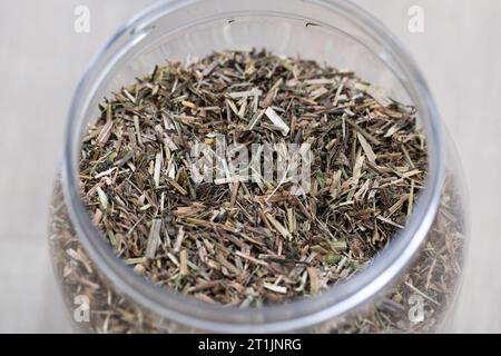 A portrait of heartsease dried loose tea in a plastic or glass jar or pot. Ready to be used in a warm relaxing beverage for some zen time. Stock Photo