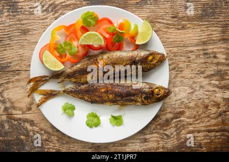 Grilled scad, Trachurus trachurus, that have been basted in a curry paste. Scad are sometimes referred to as horse mackerel. Dorset England UK GB Stock Photo