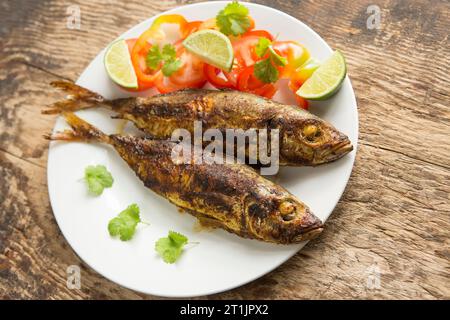 Grilled scad, Trachurus trachurus, that have been basted in a curry paste. Scad are sometimes referred to as horse mackerel. Dorset England UK GB Stock Photo