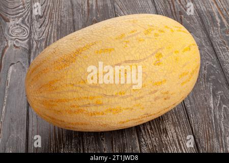 single melon on wood background Stock Photo