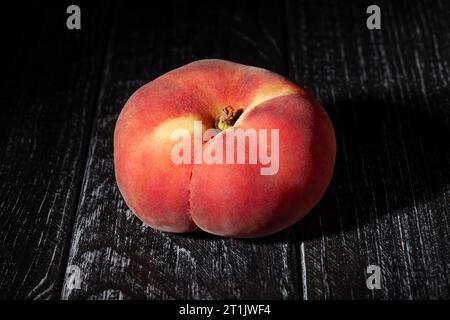 flat peach on wood background Stock Photo