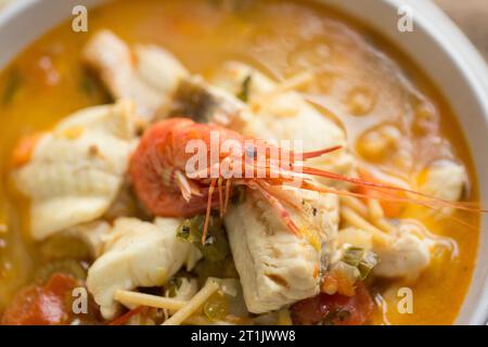 A fish soup, flavoured with saffron, containing Dover sole fillets, gurnard fillets and wild caught prawns. Dorset England UK GB Stock Photo