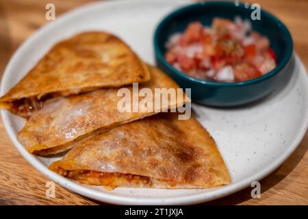 Nacho with meat, served with tomato salsa dip sauce Stock Photo