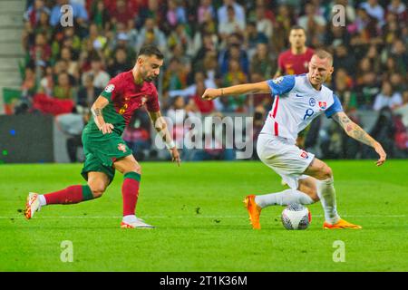 Porto, Portugal. 13th Oct, 2023. Ondrej Duda and Bruno Fernandes disputing the ball during the UEFA Euro 2024, European Qualifiers, Group J, football match between Portugal and Slovakia on October 13, 2023 at Estadio do Dragao in Porto, Portugal - Photo Jose Salgueiro/SPP (Jose Salgueiro/SPP) Credit: SPP Sport Press Photo. /Alamy Live News Stock Photo