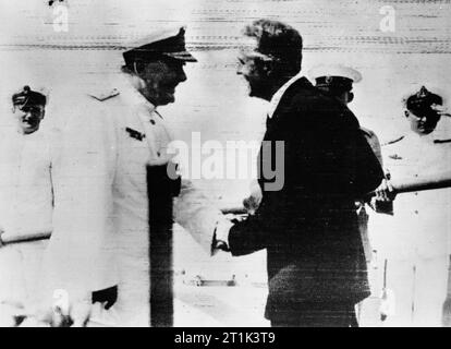 The Royal Navy during the Second World War Rear Admiral Sir Henry Harwood is greeted by the British Minister to Uruguay, Mr E Millington-Drake after his arrival at Montevideo. Admiral Harwood arrived in the cruiser HMS AJAX after the battle of the River Plate and the scuttling of the ADMIRAL GRAF SPEE. Stock Photo
