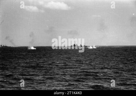The Royal Navy during World War Two As seen from the Cruiser HMS SHEFFIELD during The Battle of Cape Spartivento an engagement off Sardinia. Splashes from the shells from vessels of the Italian fleet falling short of their target a British Southampton Class Cruiser. Stock Photo