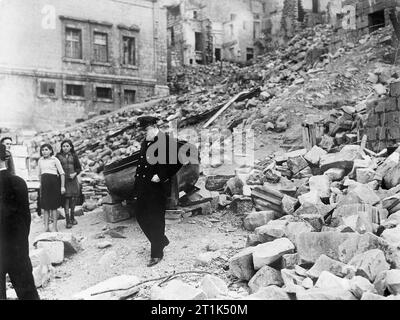 Winston Churchill inspecting air raid damage in the dockyard area of Valletta, Malta, 19 November 1943. The British Prime Minister, Winston Churchill inspects air raid damage during a visit to the dockyard at Valletta on the island of Malta. Stock Photo