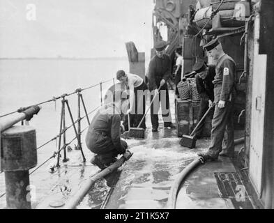 Life on Board Hm Corvette Widgeon, August 1943, in the North Sea and at Harwich, Men of the Corvette Widgeon Go About the Everyday Jobs of Their Wartime Routine. Duty men washing down decks and cleaning ship on her return to base. Stock Photo