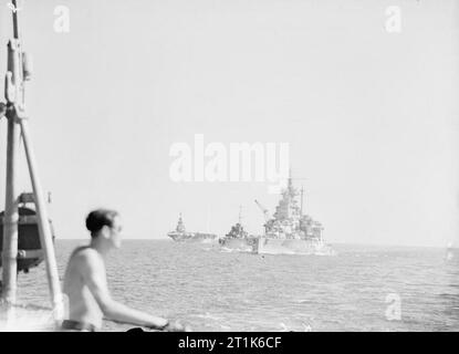 On Board the Battleship HMS Warspite. 3 July 1943, in the Sicilian Narrows, En Route From Gibraltar To Alexandria. The battleship VALIANT oiling a destroyer in the Mediterranean. HMS FORMIDABLE in the background. Stock Photo