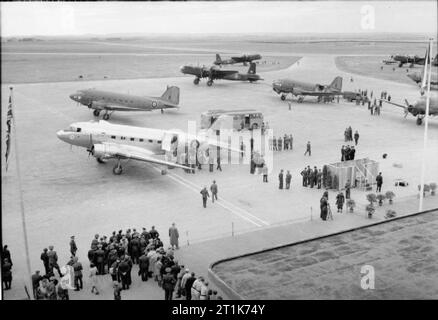 Royal Air Force Transport Command, 1943-1945. Aircraft of Transport Command parked at Prague airport, during preparations for the welcome of returning Czechoslovakian Air Force squadrons which formerly served with the RAF. Parked in the foreground are Douglas Dakotas of Nos. 46 and 47 Groups, which operated a regular air service from Croydon to Prague. The nearest aircraft is KN386 of No. 24 Squadron RAF. Behind them are Short Stirlings of No. 38 Group, which were being used to repatriate Czechoslovaks from the United Kingdom to their homeland. Stock Photo