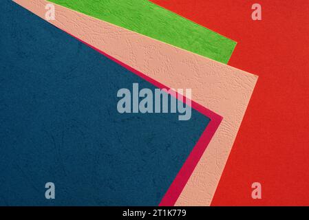 Colorful background of closeup top view of pile of cardboard sheets in different bright solid colors for creative crafts Stock Photo