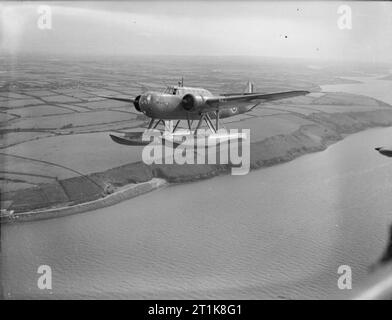 Royal Air Force Coastal Command, 1939-1945. A Fokker T-VIIIW seaplane of No. 320 (Dutch) Squadron RAF, flying west over Milford Haven after taking off from Pembroke Dock, Pembrokeshire. Stock Photo
