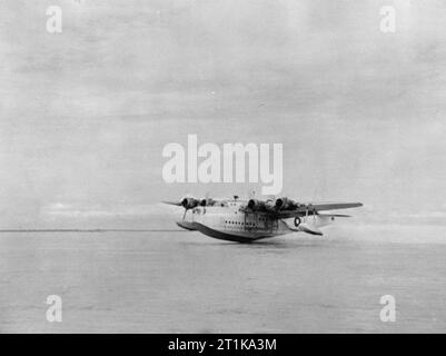 Royal Air Force Operations in the Far East, 1941-1945. Flight Lieutenant E 'Ted' Garside lands Short Sunderland Mark III, JM659 'Q', of No. 230 Squadron RAF on the Brahmaputra River at Dibrugarh, India, loaded with casualties evacuated from Burma. In June 1944, two aircraft of the Squadron were detached from their base at Koggala, Ceylon, to Dibrugarh in Assam, in order to evacuate Special Force casualties from Lake Indawgyi, situated behind the enemy front lines in northern Burma. In thirteen sorties between 2 June and 3 July, the Sunderlands evacuated some 537 men of 111th Brigade, and flew Stock Photo