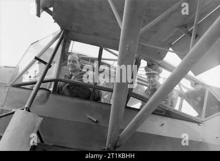 Royal Air Force- 2nd Tactical Air Force, 1943-1945. Air Vice-Marshal J H Broadhurst, the Air Officer Commanding No 83 Group (left) and Chief of the Air Staff, Marshal of the RAF Sir Charles Portal, sitting in the cockpit of Broadhurst's Fiesler Storch at B11/Longues, Normandy, during a visit by the Secretary of State for Air and the CAS to 83 Group Headquarters and airfields. Broadhurst acquired the captured Storch, which he flew as his personal aircraft, while commanding the Desert Air Force in Italy. Stock Photo