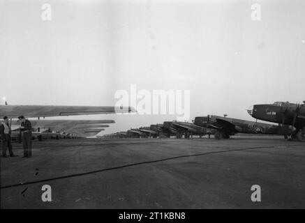 Royal Air Force- Fighter Command, No. 38 (airborne Forces) Group RAF. Operation VARSITY. A line of General Aircraft Hamilcars (left) with their tow ropes attached to Handley Page Halifax A Mark VII glider tugs of Nos. 298 and 644 Squadrons RAF, lined up at Woodbridge, Suffolk, before the evening take off for the assault on the Rhine. Stock Photo
