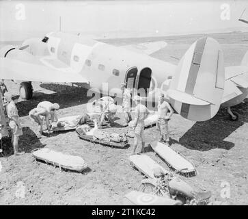 Royal Air Force- Italy, the Balkans and South-east Europe, 1942-1945. Army casualties on stretchers wait to be loaded into Lockheed Lodestar, 1371, an ambulance aircraft of the SAAF, at Catania, Sicily, for evacuation to hospitals in North Africa. Stock Photo