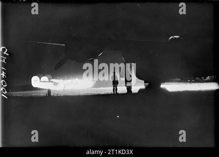 The Battle of the Atlantic 1939-1945 Anti-Submarine Weapons: A Royal Air Force Liberator illuminated by a Leigh Light on the airfield at St Eval. Stock Photo