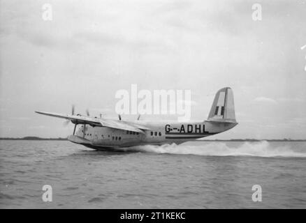 British Overseas Airways Corporation and Qantas, 1940-1945. Short S.23 'C' Class Empire Flying Boat, G-ADHL 'Canopus' of BOAC, landing on Lagos Lagoon, Nigeria, for moorings at the Iquoi  flying boat base. 'Canopus' was the first of the Empire Flying Boats, making its maiden flight on 4 July 1936 and entering service with Imperial Airways later that year. Stock Photo