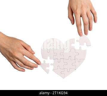 Adding missing puzzle pieces to complete love heart, repair romantic relationships Stock Photo