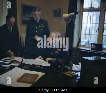 The Royal Air Force during the Second World War- Personalities Air Chief Marshal Sir Arthur T Harris, Commander in Chief of Royal Air Force Bomber Command, discussing an operation with the Senior Air Staff Officer, Air Vice Marshal R D Oxland, CB, CBE, and Mr M T Spence, OBE. Stock Photo