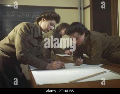 Women at War 1939-1945 The Auxiliary Territorial Service: At a Ministry of Supply experimental station, trials of rocket fuels were made to determine accuracy. Members of the ATS manned observation posts along the coast from which they observed and recorded the position of shell bursts. About 40 members of the ATS were engaged in this work. The picture shows two members of the ATS in the plotting room at Headquarters recording observations sent in from posts outside. Stock Photo