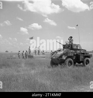 The British Army in Italy 1944 Major-General W R C Penny, GOC 1st Division, takes the salute during a march-past of 1st Reconnaissance Regiment, 23 June 1944. A Humber Mk IV armoured car passes the saluting base. Stock Photo