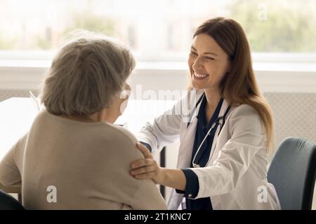 Medical worker support to old lady in clinic Stock Photo