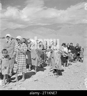 Evacuation of Polish Civilians From the Soviet Union To Persia, 1942 Group of Polish refugees, mostly women and children, tramping over the mountains from Russia into Persia. They carry whatever they can in the way of personal belongings. Stock Photo