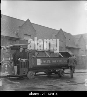 Woolmore Street Restaurant- Eating Out in Wartime London, 1942 Salvage workers Mr Aldous, Mr Major and Mr Wigington step down from their vehicle as they arrive at the British Restaurant on Woolmore Street for lunch. Stock Photo