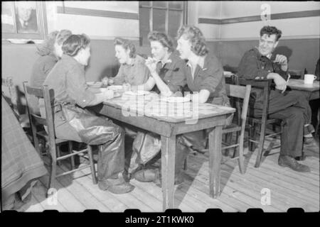 Woolmore Street Restaurant- Eating Out in Wartime London, 1942 Five women from a nearby works enjoy a meal at the British Restaurant at Woolmore Street. They women work as oil and grease fillers at the factory. Stock Photo