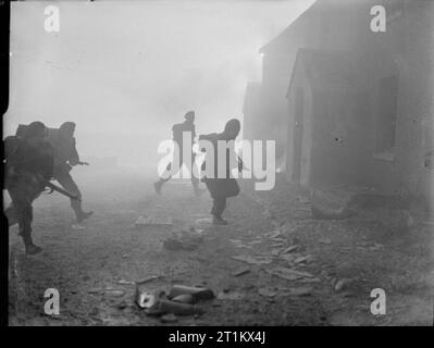 Belgian Commandos in Training in Britain, 1945 Under cover of smoke, a group of Belgian Commandos storm a building as part of a training exercise, somewhere in Britain. Stock Photo