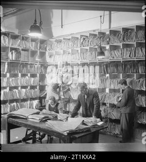 Birth of a Bomber- Aircraft Production in Britain, 1942 Workers file aircraft blue prints at the Handley Page factory at Cricklewood. Stock Photo