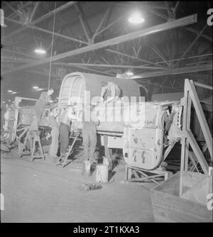 Birth of a Bomber- Aircraft Production in Britain, 1942 Aircraft workers construct part of the fuselage of a Halifax bomber at the Handley Page factory in Cricklewood. Stock Photo