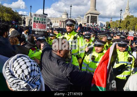 London, UK. 14th October 2023. Police scuffle with protesters  in Trafalgar Square. Thousands of people marched in solidarity with Palestine as the Israel-Hamas war intensifies. Credit: Vuk Valcic/Alamy Live News Stock Photo