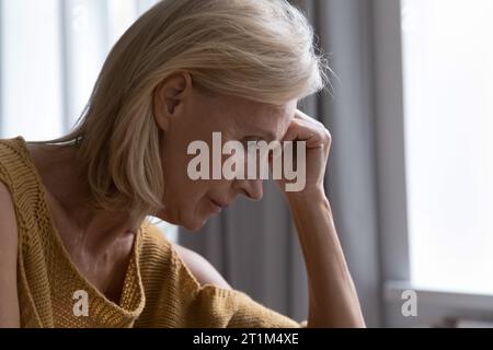 Sad thoughtful lonely elderly lady suffering from apathy, depression Stock Photo
