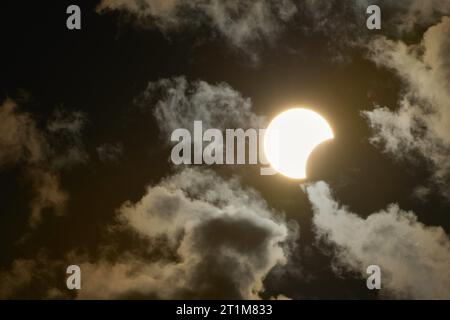 Socorro, Brazil. 14th Oct, 2023. Partial solar eclipse is seen between clouds from Socorro, Sao Paulo, Brazil, on October 14, 2023. (Photo by Igor do Vale/Sipa USA) Credit: Sipa USA/Alamy Live News Stock Photo