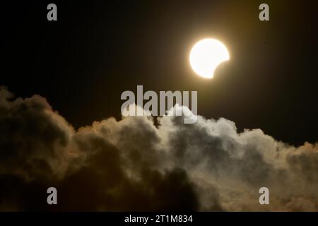 Socorro, Brazil. 14th Oct, 2023. Partial solar eclipse is seen between clouds from Socorro, Sao Paulo, Brazil, on October 14, 2023. (Photo by Igor do Vale/Sipa USA) Credit: Sipa USA/Alamy Live News Stock Photo