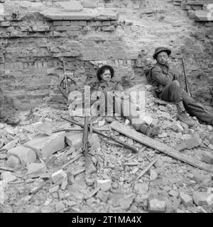 The British Army in North-west Europe 1944-45 Two soldiers of the 3rd Monmouthshire Regiment resting after a period in the front line, 2 March 1945. Stock Photo