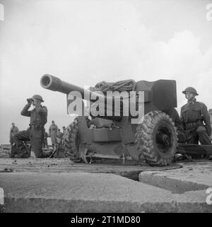 PRACTICE SHOOT by 6-PDR. ANTI-TANK GUNS - Gun crews prepare a 6-pounder ...