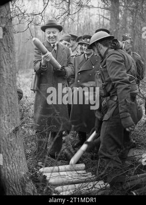 British Political Personalities 1936-1945 The Churchill Coalition Government 11 May 1940 - 23 May 1945: The Minister of Economic Warfare, Dr Hugh Dalton, holding a shell during a visit to Czech troops stationed in the Western Command. Stock Photo