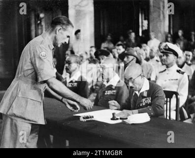 Japanese Surrender of Singapore, 1945 A member of the Japanese delegation signs the document of surrender in Singapore on 12 September 1945. Stock Photo