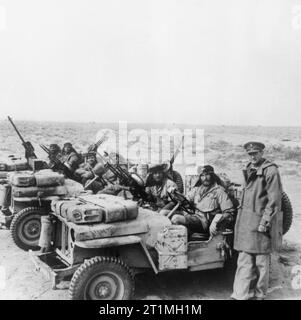 Colonel David Stirling, founder of the Special Air Service, with an SAS jeep patrol in North Africa, 18 January 1943. The Axis Offensive 1941 - 1942: A Special Air Service jeep patrol is greeted by its commander, Colonel David Stirling, on its return from the desert. Stock Photo