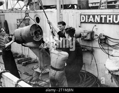 The Battle of the Atlantic 1939-1945 Anti-Submarine Weapons: A Mk VII depth charge being loaded onto a Mk IV depth charge thrower on board HMS DIANTHUS. Stock Photo