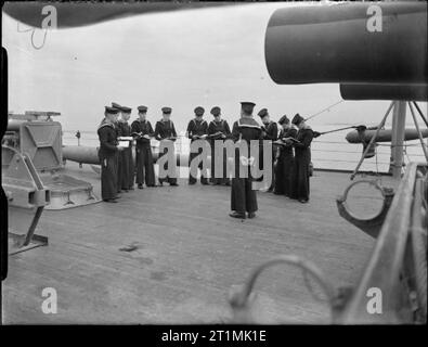 The Royal Navy during the Second World War On board HMS RODNEY a seamanship class in progress on deck for ordinary seamen. Here they are on deck with their manuals. Stock Photo