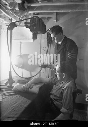 The Royal Navy during the Second World War Medicine at Sea: X-ray equipment in use in the sick bay on board HMS RODNEY. Stock Photo