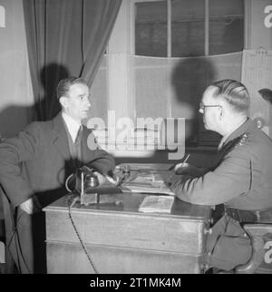 A Recruit Joins the British Army At the drill hall in Duke's Road, Euston, London, a prospective recruit is interviewed by the commanding officer. Stock Photo