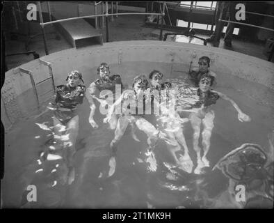 The Royal Navy during the Second World War Davis apparatus brings submarine-trapped men to safety at HMS DOLPHIN, Gosport. Here a class of submarine trainees are floating in the instructional tank before going down into the escape chamber. Stock Photo