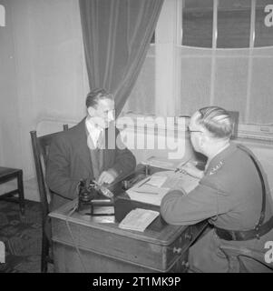 A Recruit Joins the British Army At the drill hall in Duke's Road, Euston, London, a prospective recruit is interviewed by the commanding officer. Stock Photo