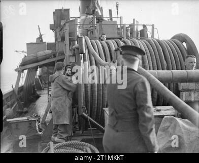 The Royal Navy during the Second World War Hands working the drum to stream the L L sweeping gear used to detonate magnetic ground mines on board HM Minesweeper 1023 during sweeping operations in the North Sea. Stock Photo